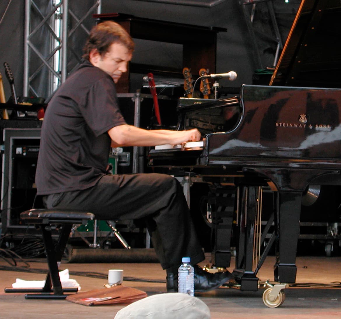 Pianist Brad Mehldau seated at a grand piano during a live performance.